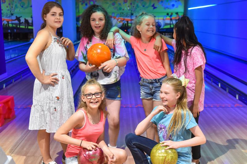 Children having fun ten pin bowling