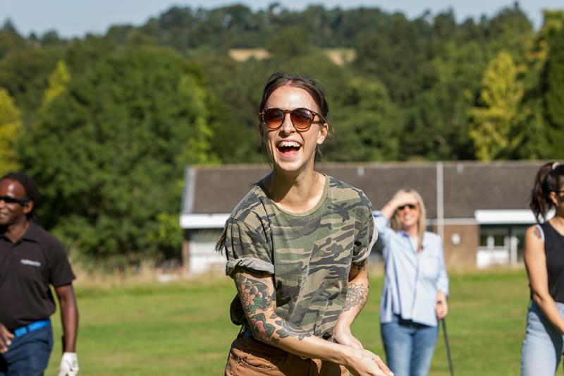 People enjoying playing golf on a sunny day